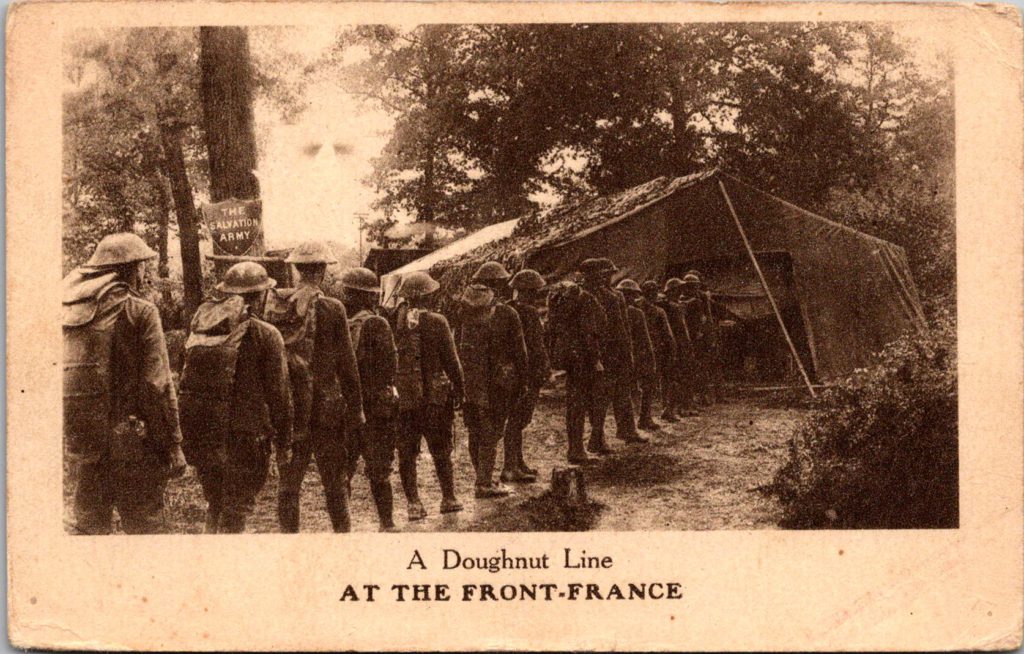 Postcard of American soldiers lining up outside of a Salvation Army aid tent at the front during WW1 in France