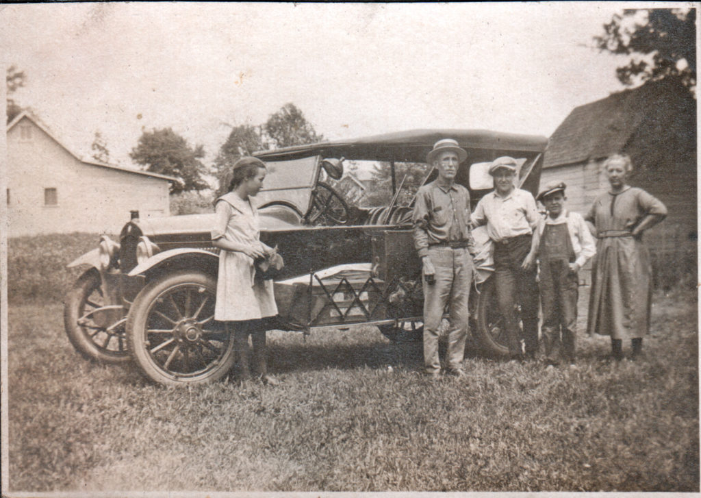Family around old car